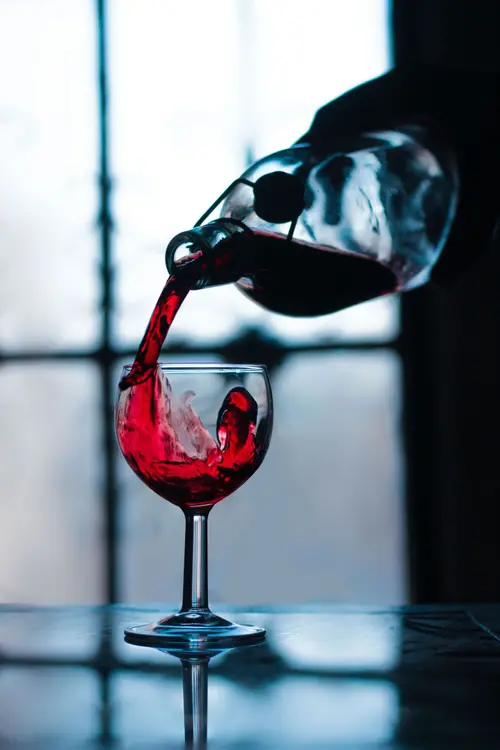 Red wine being poured into a glass