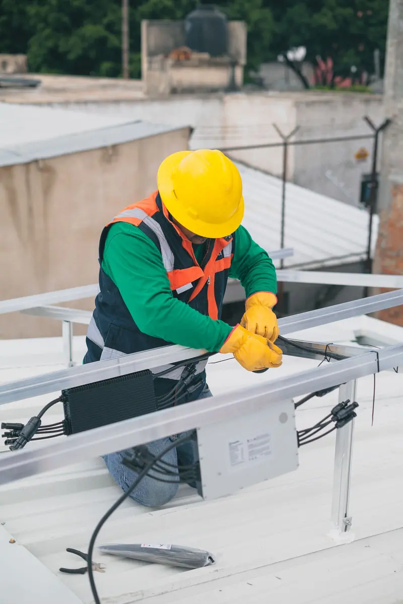 Electrical technician in safety gear working on an installation