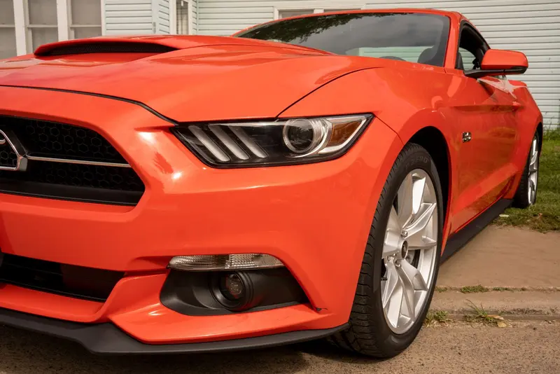 Glossy orange sports car after a full detail